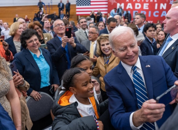 President Biden takes a selfie with event attendees in Syracuse.
