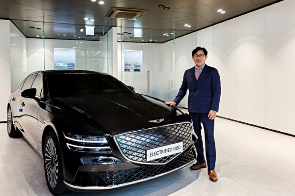 현대자동차 서울 서대문중앙지점 최진성 영업이사(56)가 자신이 7,000번째로 판매한 ‘제네시스 G80 전동화 모델’ 앞에서 포즈를 취하고 있다. 사진=현대자동차.