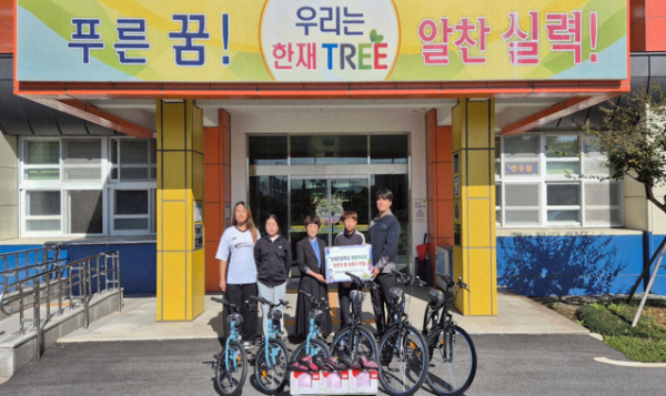 한재초등학교에 자전거와 안전보호구를 전달하는 모습. 사진 ((왼쪽부터) 한재초 학생임원진, 정월선 교장, 한솔페이퍼텍 HR지원팀 정진호 선임)=한솔홀딩스.